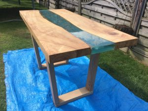 A fantastic river table made from a slab of olive ash we sold